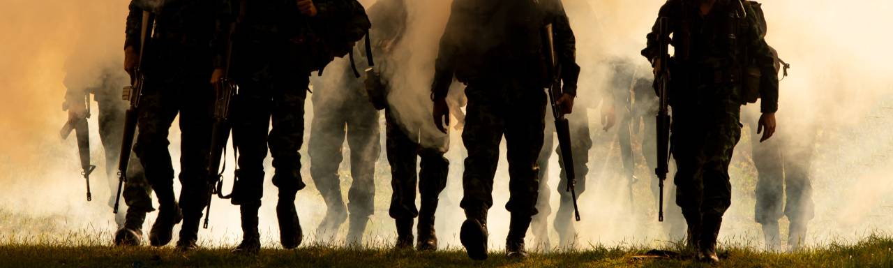 soldiers walking with orange mist